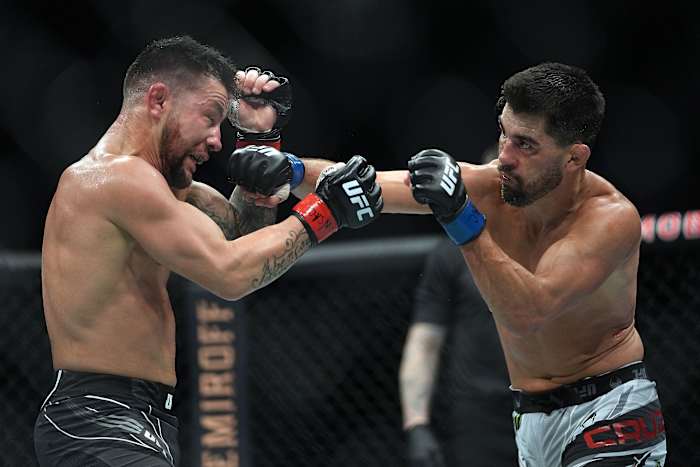 Pedro Munhoz defends against Dominick Cruz during UFC 269 at T-Mobile Arena.